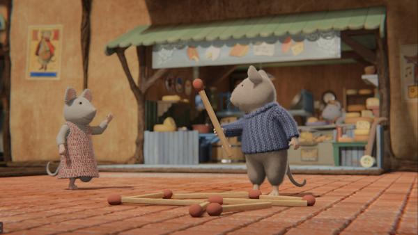 Bild 1 von 2: Julia (links) beschreibt Sam (rechts), wie ihr Haus auf ihrer Heimatinsel ausgesehen hat. Sam legt den Grundriss mit Streichhölzern nach.