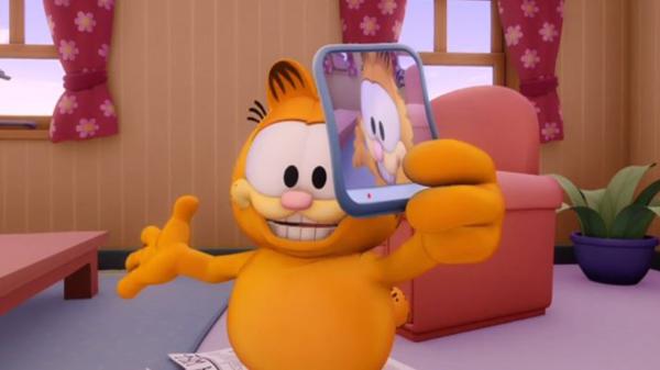 Bild 1 von 2: Garfield hat Jons neues Smartphone als Spielzeug entdeckt und dreht einige Videos damit. Er filmt Jon bei ein paar tollpatschigen Situationen.