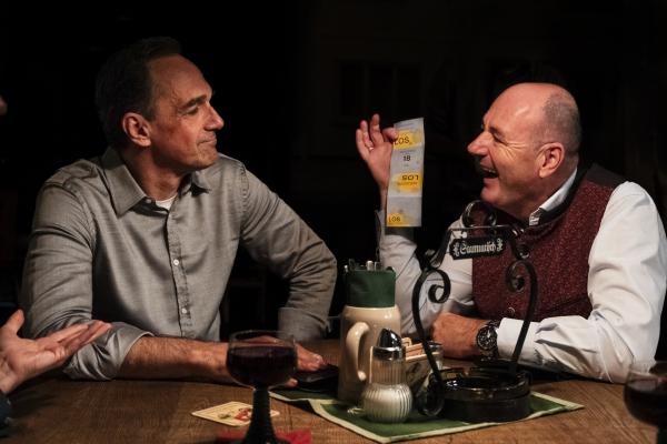 Bild 1 von 5: Hubert (Bernhard Ulrich, rechts) zeigt Mike (Harry Blank, links) sein Los mit einer hohen Losnummer und gibt somit sein Interesse an Winklers Spende preis.