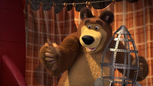 Bild 1 von 4: Der Bär und das Raketenmodell.