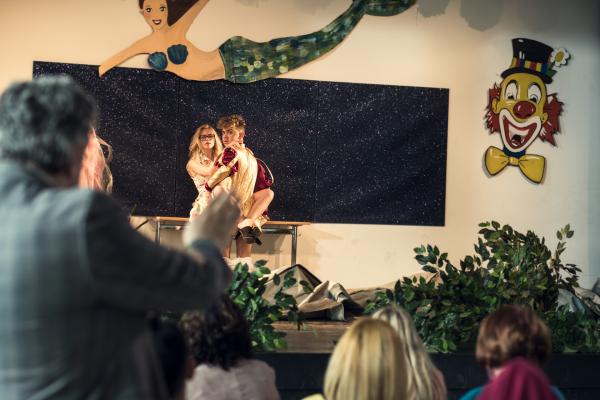 Bild 1 von 3: Deniz (Levin Alin, r.) und Frau Bischoff (Jeanne Goursaud, l.) vergnügen sich Backstage während einer Ballettaufführung, als plötzlich der Vorhang fällt.