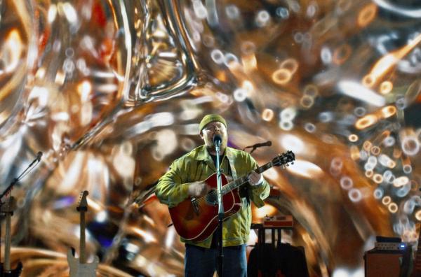 Bild 1 von 2: Eine große LED-Leinwand wird von Visual Artists bespielt - und zwar passgenau zu der Musik des Gitarristen Tom Walker.