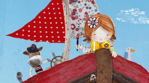 Bild 1 von 4: Lily freut sich, dass sie einen Pinsel am Strand gefunden hat.© KiKA/Sixteen South - Honorarfreie Verwendung gemäß AGB im redaktionellen Zusammenhang mit genannter Sendung bei Nennung \