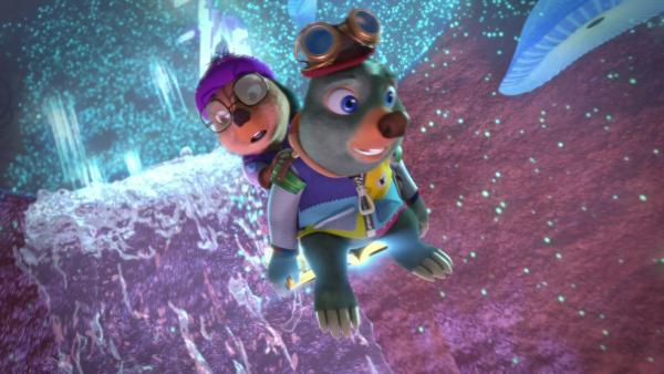 Bild 1 von 3: Auf seinem magischen Buch Mauli sitzend, fliegen Moley und Dotty, auf der Suche nach dem geheimnisvollen Schatz, durch eine bizarre, glitzernde Unterwelt.