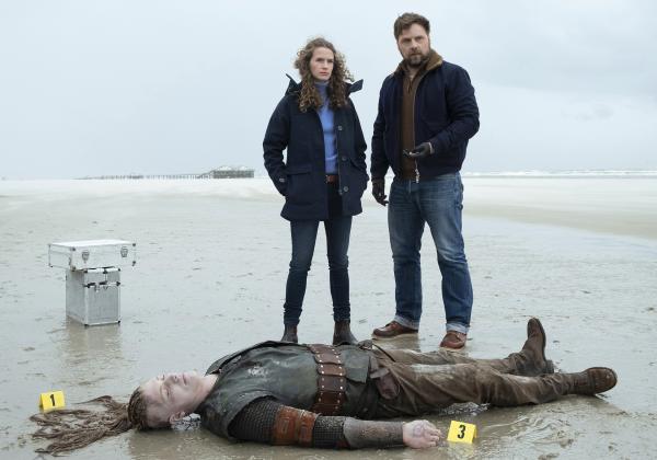 Bild 1 von 1: Eine Leiche in Wikingerkluft (Gunnar Graumann, unten): Kommissarin Ria Larsen (Marlene Tanczik, l.) und ihr früherer Partner Brandt (Christoph Letkowski, r.) sind vor Ort.