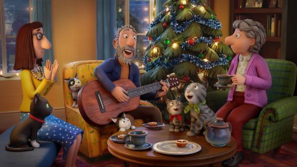 Bild 1 von 9: Zur Weihnachtszeit in glücklicher Runde: Straßenmusikant Matze mit den Nachbarinnen Dame und Frau Brille und der jungen Katzenfamilie.