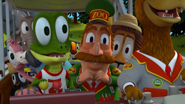 Bild 1 von 3: Zacki, das Krokodil, hat die Bahn erfolgreich repariert. Nun kann sie sich wieder in alles Mögliche verwandeln. Stolz will die Zoobande Herrn Timmer, dem Zoodirektor, eine Verwandlung vorführen.