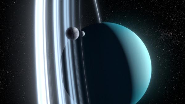 Bild 1 von 3: Uranus, der siebte Planet, umkreist die Sonne auf einer stark geneigten Achse. Seine Ringe und Monde bewegen sich im Verhältnis zur Sonne und den anderen Planeten senkrecht um den Eisriesen.