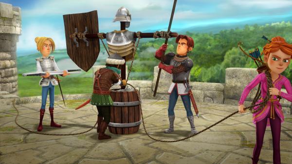 Bild 1 von 7: Tristan, Sagramor, Gawain und Guinevere bauen Vogelscheuchen in Rüstungen. Von weitem soll es aussehen, als sei die Burg voller Soldaten.