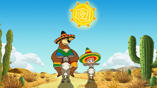 Bild 1 von 6: ascha und der Bär reiten auf Eseln in der Wüste.