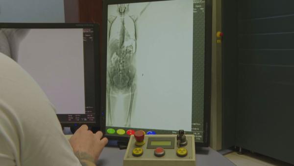 Bild 1 von 3: Beim Blick auf den Röntgenmonitor entdecken die Zollbeamten Unregelmäßigkeiten.