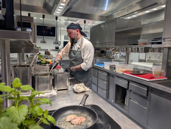 Bild 1 von 21: Koch Michael Muhler vom Weßner Hof bereitet die Hauptspeise vor: 3erlei vom Weßner Hof Hendl, mit Limettensahne, Urkarotten und Weißweinrisotto.
