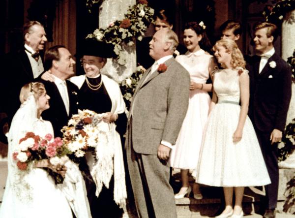 Bild 1 von 6: Onkel Pankraz (Hans Nielsen, Mitte) gratuliert seiner Tochter Margot (Karin Andersen, li.) zu ihrer Hochzeit mit Jochen von Roth (Paul Kliner, 3. v. re.). Der reiche Winzer hat außerdem Oma Jatzens (Margarethe Haagen, 4. v. li.) Immenhof gerettet. Die Zukunft von deren Enkeln Dick (Angelika Meissner-Voelker) und Dalli (Heidi Brühl, re.) ist damit gerettet. Cousin Ethelbert (Matthias Fuchs, re.) hatte an dieser Rettung maßgeblichen Anteil.