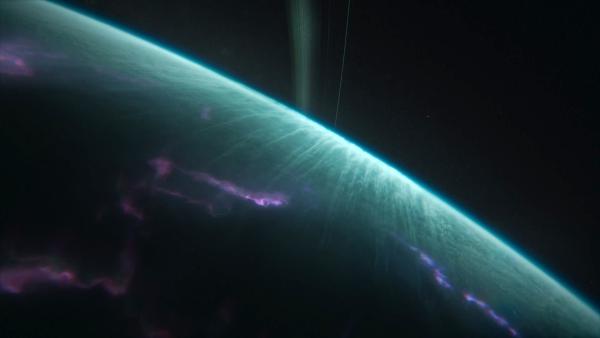 Bild 1 von 4: Der Eisriese Uranus überrascht mit einem buntem Leuchten in seiner Atmosphäre. Es erinnert an das Polarleuchten auf der Erde.