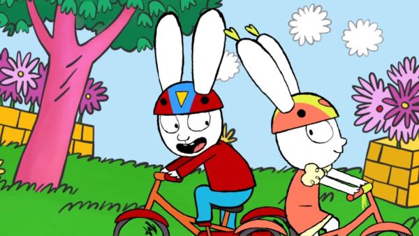 Bild 1 von 3: Im Park haben Simon (l.) und seine Freundin Lou (r.) großen Spaß beim gemeinsamen Fahrradfahren.