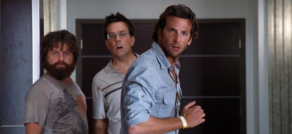 Bild 1 von 6: Zach Galifianakis as Alan standing with Ed Helms as Stu and Bradley Cooper as Phil, all staring with expression of surprise.