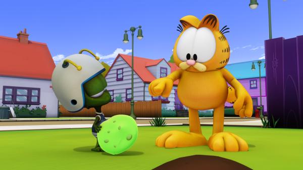 Bild 1 von 3: Als Nimbus, der kleine Alien-Freund von Garfield und Odie, mit seiner fliegenden Untertasse auf der Erde einen Zwischenstopp einlegt, schenkt er Odie einen ganz besonderen Hundekeks.