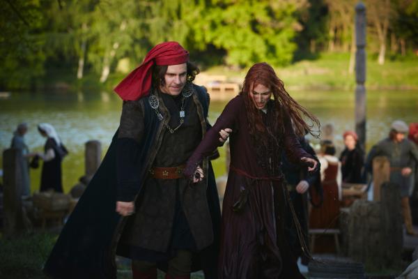 Bild 1 von 7: Ein Hexenjäger (Paul Sedlmeir) führt eine Frau nach missglückter Wasserprüfung zum Scheiterhaufen.