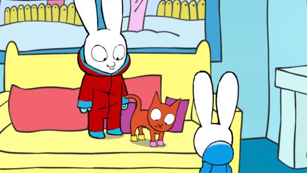 Bild 1 von 3: Stolz verpassen Simon (l.) und Franz (r.) Oskar (M.) zwei Paar Schneestiefel. Der Kater ist davon allerdings alles andere als begeistert.