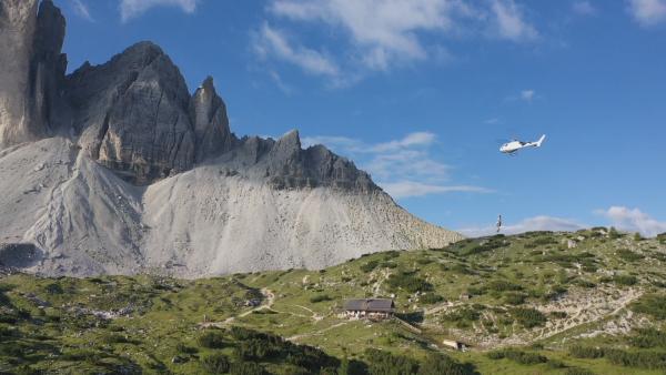 Bild 1 von 11: Warentransport mit dem Helikopter. Hubschrauber-Pilot Hansi Tschurtschentaler fliegt eine Hütte unterhalb der Drei Zinnen an.