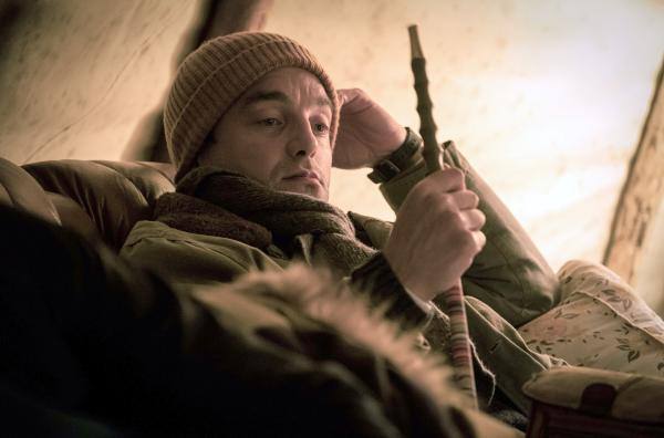 Bild 1 von 5: Major Louvetot (Guillaume Gouix) raucht eine Pfeife beim Schamanen im Wald.