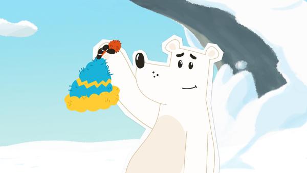 Bild 1 von 1: Grumpel ist begeistert: Irgendjemand hat ihm eine warme Mütze gestrickt und in die Nähe seiner Höhle gelegt. Aber wer war das wohl? Das will er nun unbedingt herausfinden - denn da scheint ihn jemand sehr zu mögen.