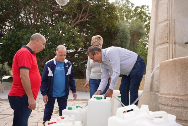 Bild 1 von 4: Im Bild: Mariagrazia und Salvatore Costanza befüllen den Tank auf ihrem Haus mit Wasser, das sie mit Kanistern von öffentlichen Wasserstellen geholt haben.