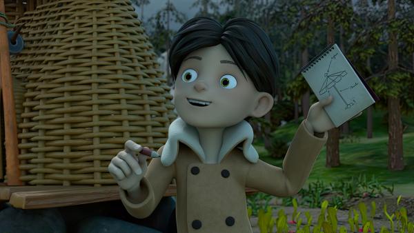 Bild 1 von 3: Als sich der Himmel über Frondosa verdunkelt, präsentiert Klincus den Bewohner*innen stolz seinen Plan für seinen riesigen Regenschirm, der die geplante Party retten soll.