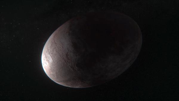 Bild 1 von 3: Haumea, ein Zwergplanet im Kuipergürtel, ist sehr weit vom Mittelpunkt des Sonnensystems entfernt. Seine Eiform widerspricht eigentlich den Gesetzen der Schwerkraft.