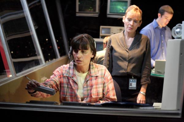 Bild 1 von 3: RE-ENACTMENT STILL:  Robin Wascher (played by Jacqueline Pillon) looks at her flight strip.