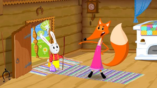 Bild 1 von 3: Die Füchsin setzt den Hasen vor die Tür.