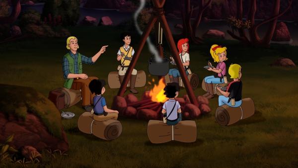 Bild 1 von 5: Trainer Frank (l.) genießt mit den Kindern den lauen Abend am Lagerfeuer.