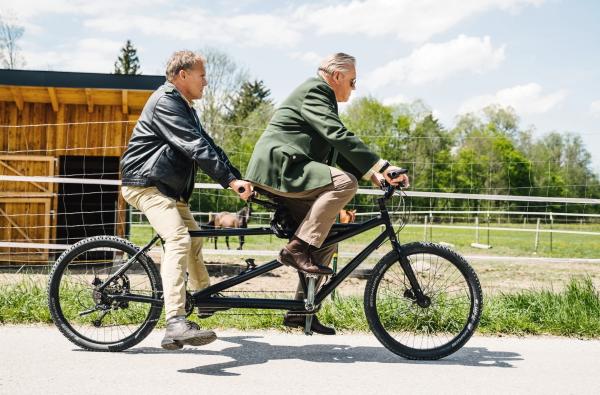 Bild 1 von 2: Hubert (Christian Tramitz, l.) und Girwidz (Michael Bradner, r.) testen ein alternatives Fortbewegungsmittel. Man sieht, Hubert hat das Prinzip \