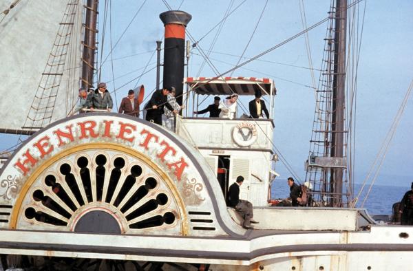 Bild 1 von 11: Full publicity shot of David Niven as Phileas Fogg (in steerage hose in yellow vest) riding on a steamboat.