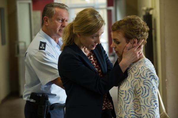 Bild 1 von 5: Eindringlich redet Maike Wagner (Silvina Buchbauer, M.) auf ihre Freundin Franka Turner (Greta Galisch de Palma, r.) ein und versichert ihr, dass alles wieder gut werden wird. Ein Beamter (Komparse, l.) versucht die beiden zu trennen.
